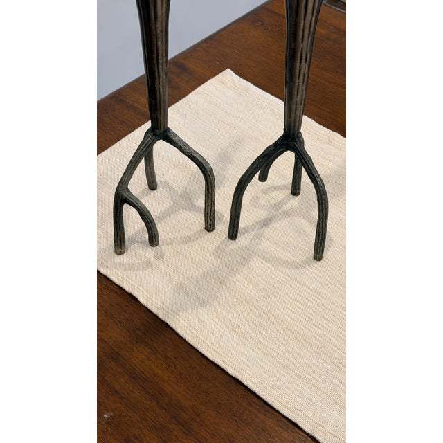 A striking pair of sculptural candle holders featuring an organic, branch-like form with a refined brutalist edge. Their...