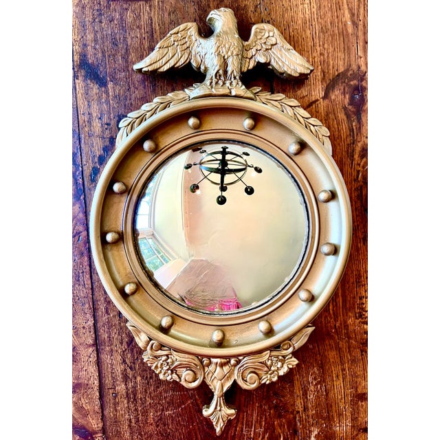 Vintage small traditional federal mirror with carved eagle at top. Slightly convex shape, border mounted with 13 spheres...