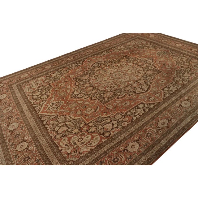 Hand-knotted in wool, circa 1890-1900, this 10x16 antique Persian Tabriz rug, has finely detailed floral patterns in...