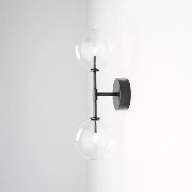 Dawn dual brass wall sconce by schwung dimensions: w 19 x d 15 x h 47.5 cm materials: black gunmetal, hand blown glass...