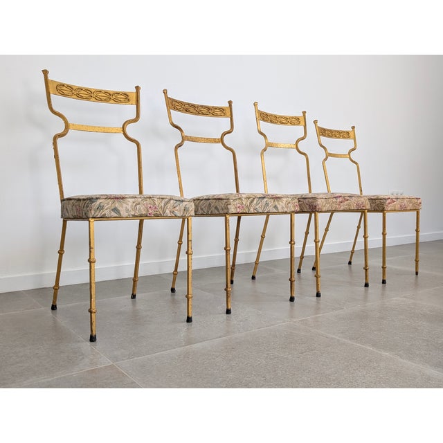 An elegant set of four wrought iron chairs with a striking gold finish and a sculptural silhouette. Made in Spain in the...