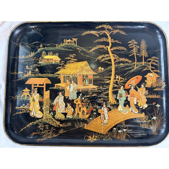 This is a large rectangular lacquer tray featuring an elaborate Chinoiserie landscape rendered in gold and polychrome...