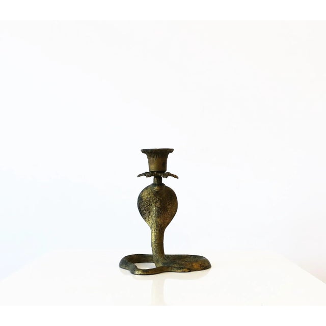 A substantial metal cobra snake candlestick holder with gold gilt skin, circa early-20th century. Also great as a...
