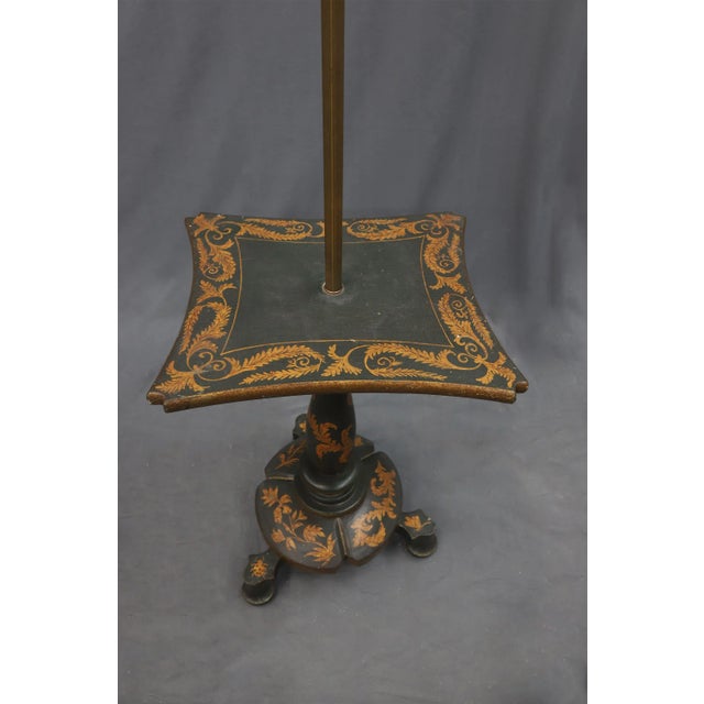 Floor lamp and table in one. The edges are decorated in gold color leaves, which are also featured on the bottom tripod...