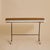 An Italian console or desk executed in the manner of Luigi Fornasari, from the 1950s. The streamlined rectangular top is...