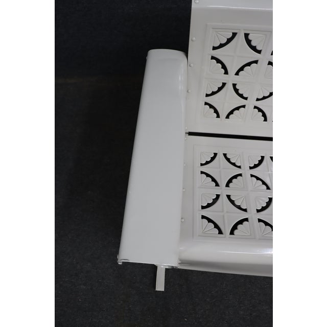 Classic 1950s American metal porch glider, fully restored in a crisp white finish. The bench features distinctive...