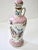 Antique hand painted decorative whiskey porcelain decanter with coat-of-arms shield and floral motif. The decanter has a...