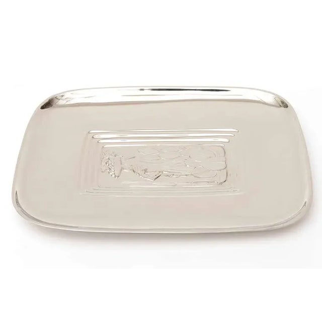 Exotic depictions of embellished and embossed Diego Rivera imagery are the center of this polished silver-plate serving...