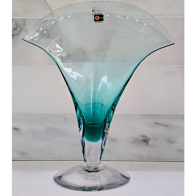 Striking Blenko art glass vase featuring a dramatic ruffled, flared rim in vibrant turquoise that fades elegantly into a...
