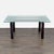 Glass top with wood legs. When extended, the table expands to 105 inches. Dimensions (in): 67W x 40D x 30H.