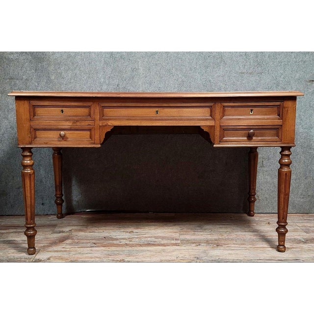 Louis Philippe period flat desk in walnut, circa 1830. It features four drawers in the frieze, disguised as five. The...