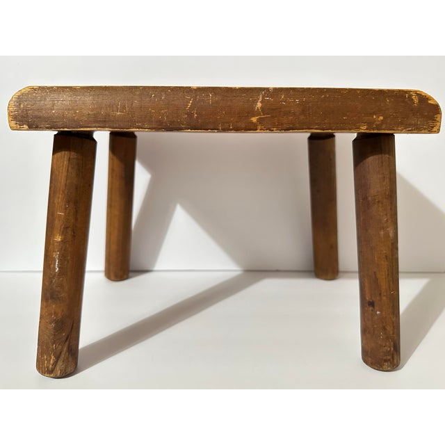 Vintage Mid 20th Century hand-painted wooden footstool. Rectangle shaped top with rounded corners, four turned cylindrical...