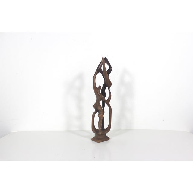 Beautiful hand carved abstract biomorphic wood sculpture. I see acrobats or dancers. What do you see? The sculpture is...