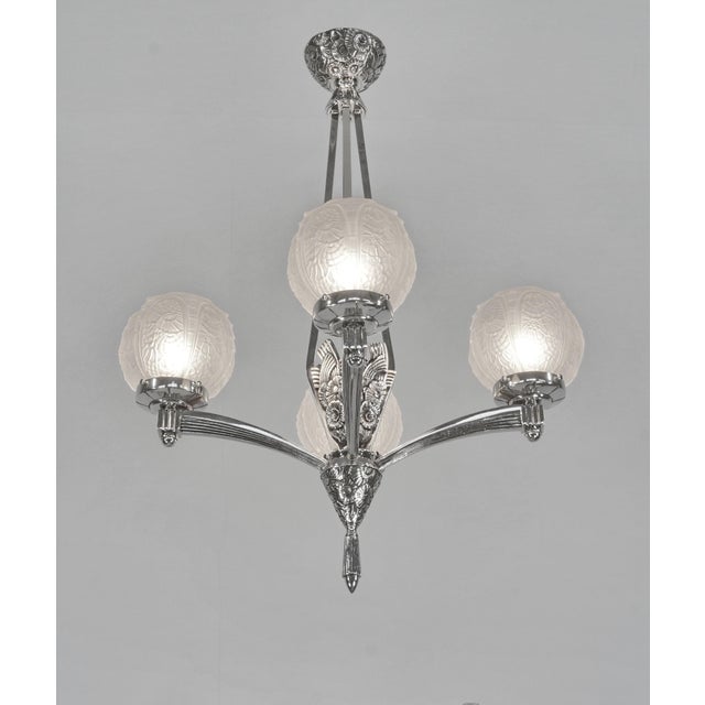 Louis Vandamme A French art deco chandelier crafted circa 1930 in nickel plated solid brass or bronze. The beautiful...