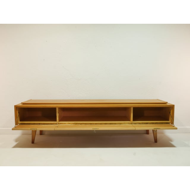 This vintage sideboard/lowboard is an original piece from the 1960s and was originally part of a living room cabinet. The...