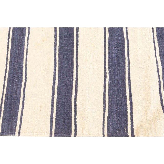 Vintage Indian Dhurrie Striped rug Size: 3'6" × 6'5" (106 × 195 cm) This vintage Indian Dhurrie rug presents a timeless...