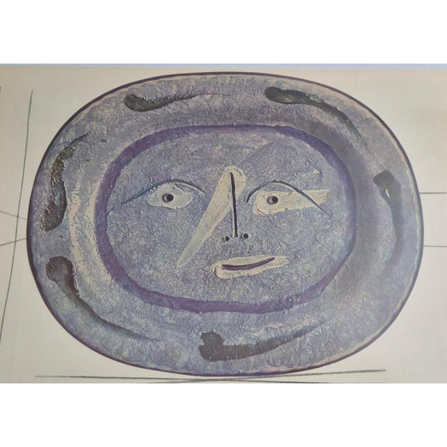 An exquisite collection of twp framed shiny polychrome prints of Picasso Vallauris ceramic plates depicting faces. The...