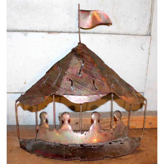 Striking mid-century wall sculpture crafted in hand-tooled copper, featuring a whimsical and dynamic carnival scene. This...