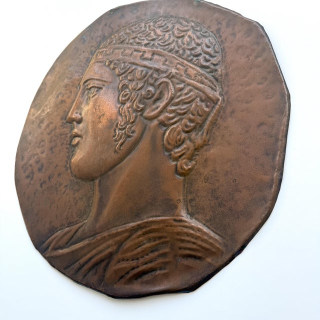 A striking vintage copper wall plaque featuring a highly dimensional classical profile rendered in repoussé relief. The...