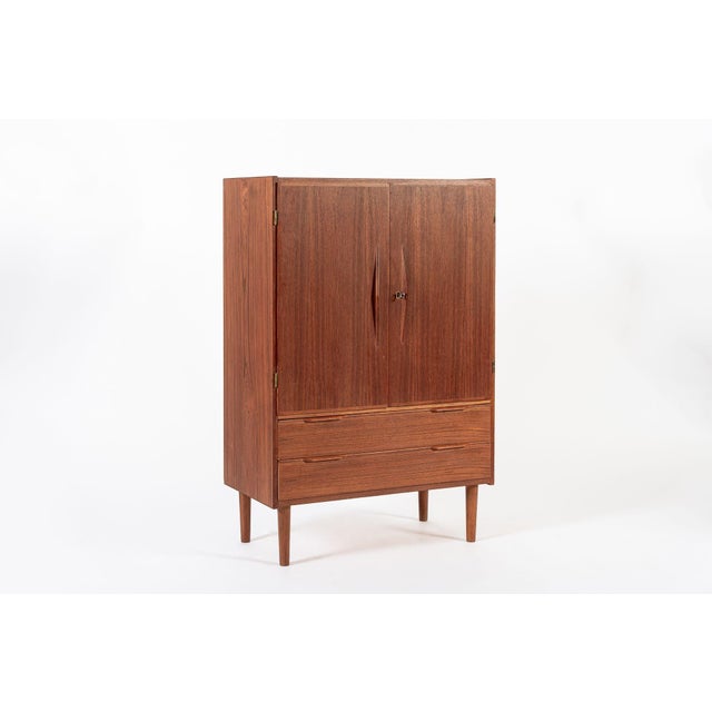 This vintage mid century Danish modern teak storage or bar cabinet was made in Denmark circa 1960. The classic...