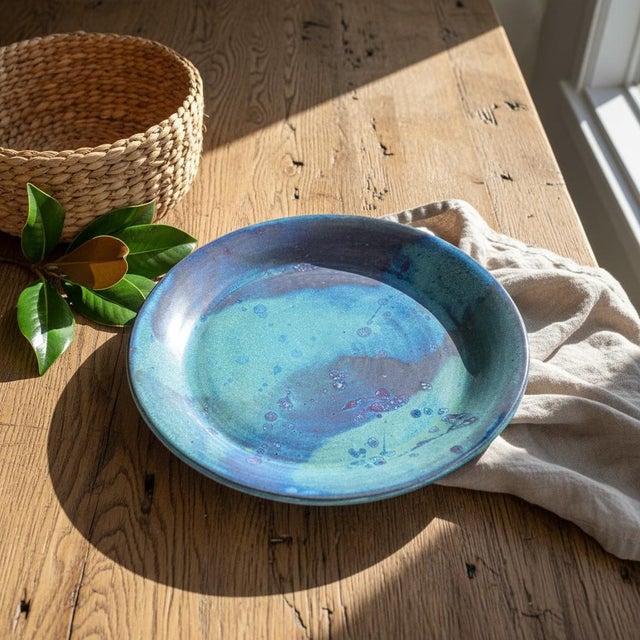 This striking signed studio art pottery platter was hand-thrown and high-fired in the United States, likely during the...
