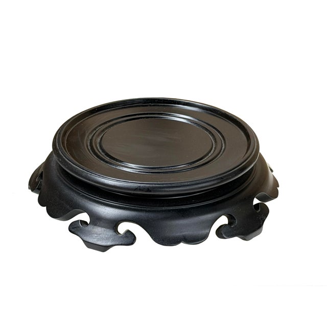 Crafted from dark, polished wood, this traditional circular display stand features a smooth, recessed platform designed to...