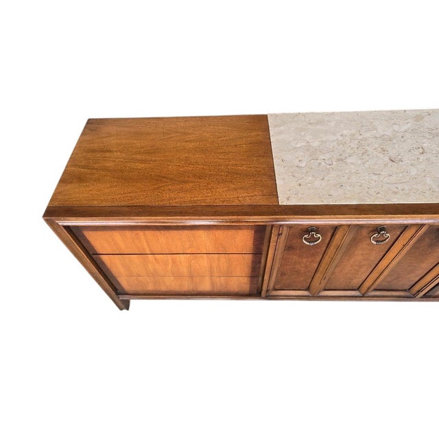 A classic mid-century modern triple dresser by Witz Furniture, crafted in the United States and showcasing the clean lines...