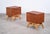 Elegant pair of bedside tables produced in Denmark during the 1960s. Crafted with teak cabinets and solid oak frames, the...