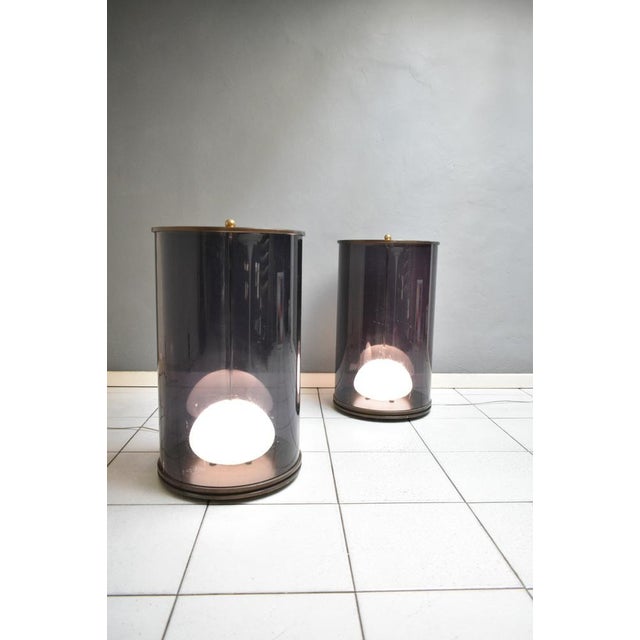 Pair of light columns. The columns/lamps have a brass and acrylic structure with glass diffusers inside. They can be used...