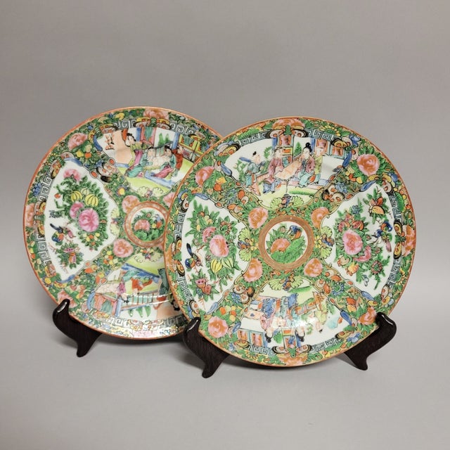 Pair of vibrant 1940's era hand-painted Rose Medallion porcelain plates with a distinctive blue fret key border that...