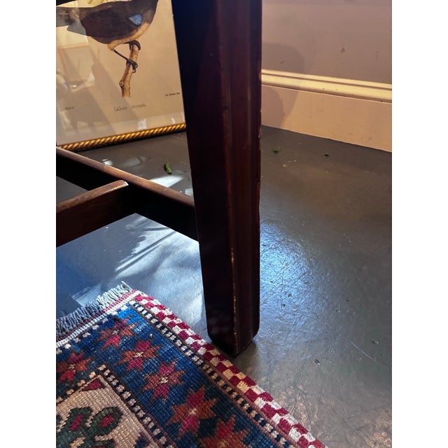 This is an antique camelback sofa. . It is Chippendale style. It has a mahogany base. It is made in the 1800s. The fabric...