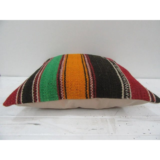 This is a pillow cover made from a vintage kilim rug. The piece was properly washed and ready to use. Pillow inserts not...