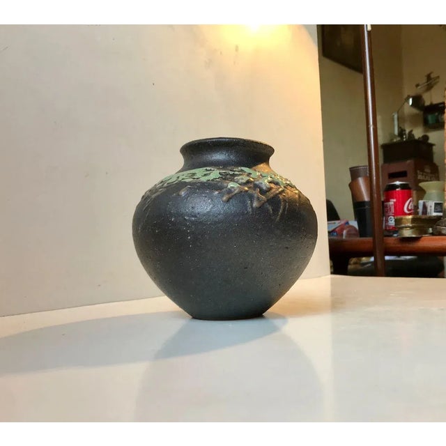 A piece unique from the Danish west coast ceramist Palle S. Nielsen. It has a black main glaze and is decorated in an...