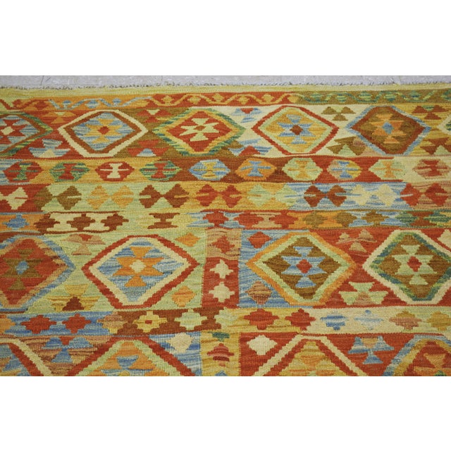 Vintage Afghan Maimana hand woven kilim with natural colors and geometric pattern.