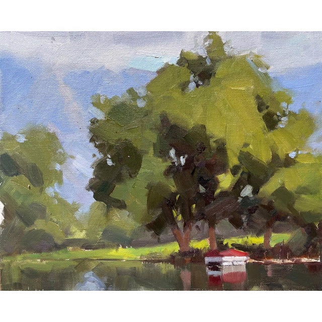 A serene landscape unfolds, featuring a small red boat gently anchored amidst lush greenery and tranquil waters. The...