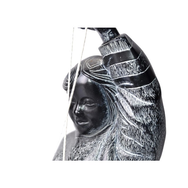 Boma black and white hand-carved Wood sculpture of an Eskimo fishing for salmon. Original label on underside.