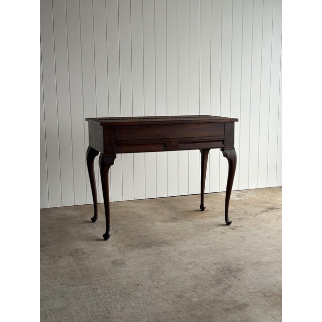 Antique solid mahogany spinet writing desk raised on cabriole legs with a hinged writing surface. Interior fitted with...