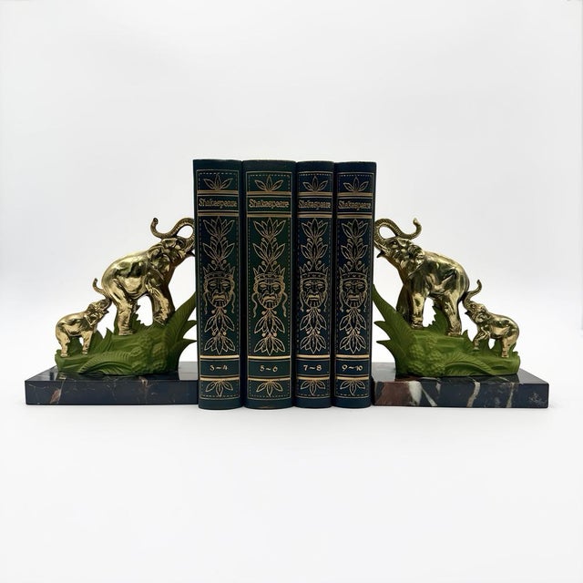 Elegant and full of character, this pair of bookends features two majestic gilded brass elephants with their calves, set...