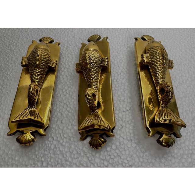 Topped with a shell finial and mounted on a long rectangular shield-shape backplate is this highly detailed etched koi...