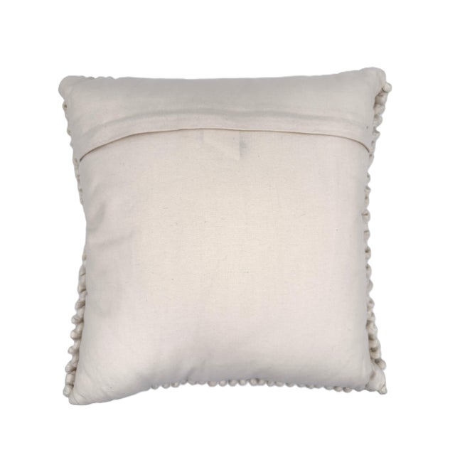 Featuring a tactile, handwoven “pebble” texture made with hand-dyed wool on the front, this beautifully handcrafted wool...