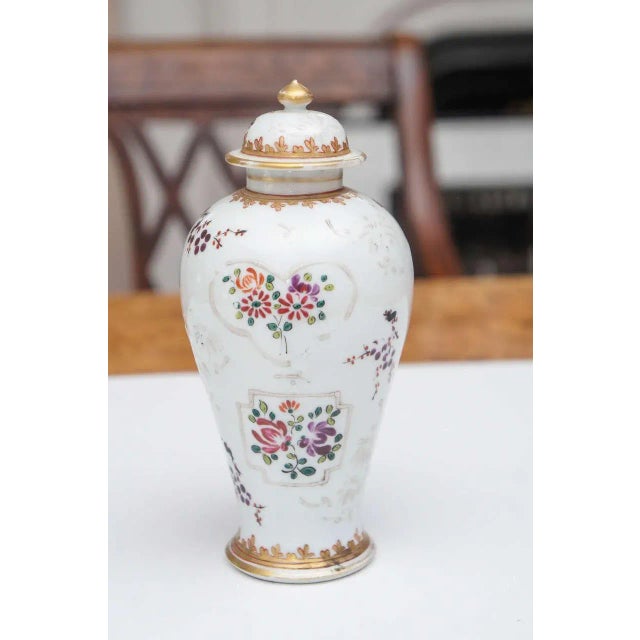 Samson porcelain vase with lid, circa 1900. Baluster form with white floral decoration, scrolls and gilt. Iron-red trim.