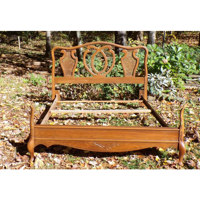 Vintage French Provincial French Country Style Cane Full Double Bed frame, made of Walnut wood. The sculptural headboard...