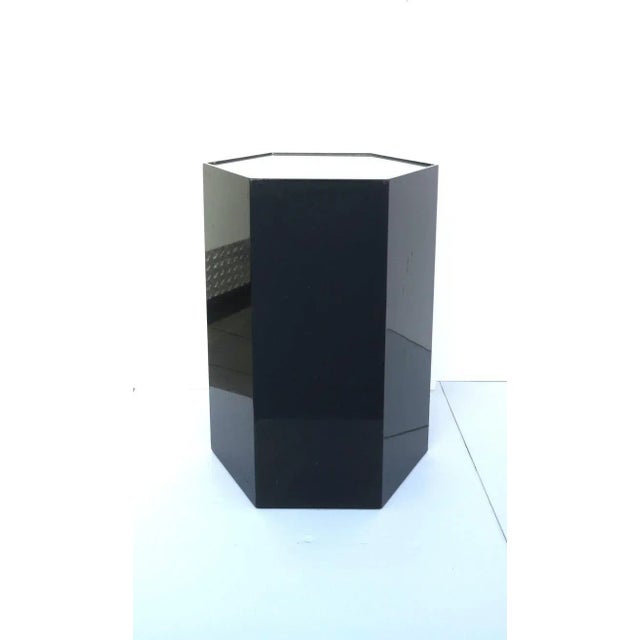 A substantial and well-made black high-gloss pedestal column pillar stand or table, in a hexagon shape, glass top, with...