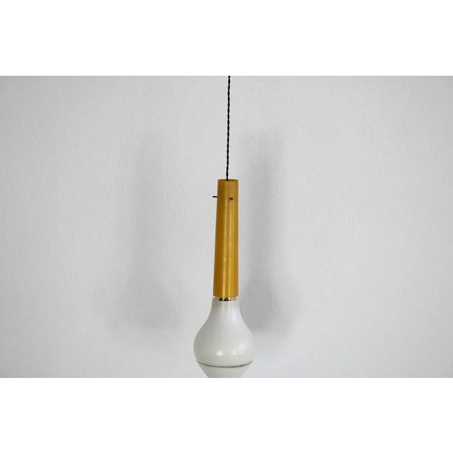 This Italian pendant people comes from 1960s. This Italian pendant lamp comes from the 60s. While the upper part of the...