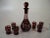 Offering a set of six liquor tumblers and Decanter Made Czech / Bohemian of Ruby-stained glass that has been Hand Wheel...