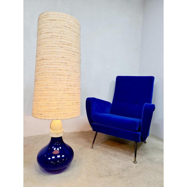 An absolute eye-catcher this rare blue glass floor lamp with a beautiful nature linen look high roof. Period: 60s....