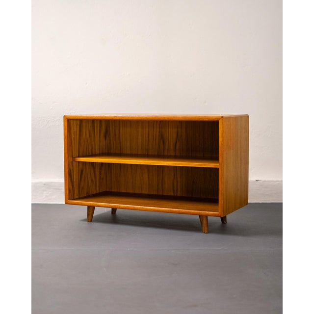 An essential piece of 1960s Scandinavian design, this versatile low teak bookcase encapsulates the beauty of clean lines...