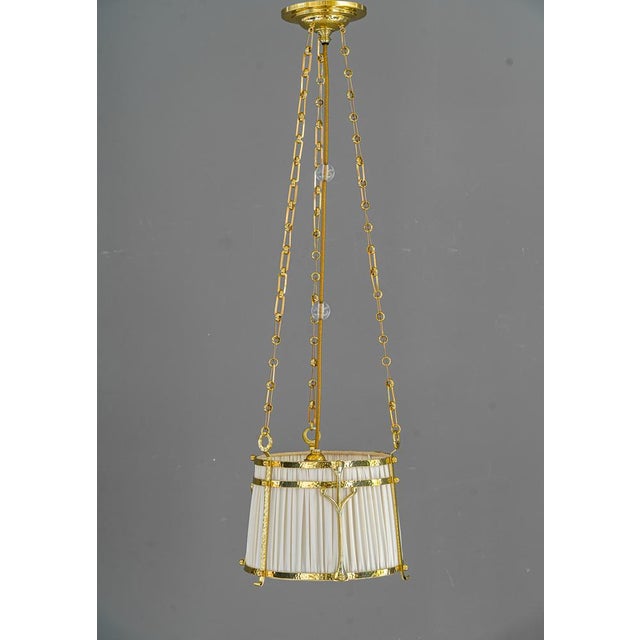 Art Deco pendant, Vienna, around 1920s. Polished and stove enameled. Hammered brass and fabric shade. The fabric is...