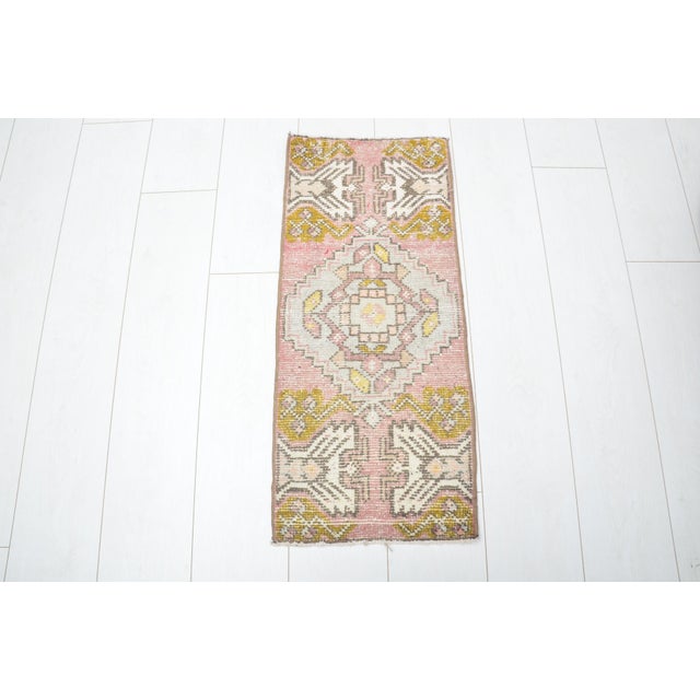 This is a vintage Turkish nomadic wool rug. The piece was handmade in the 1960s.