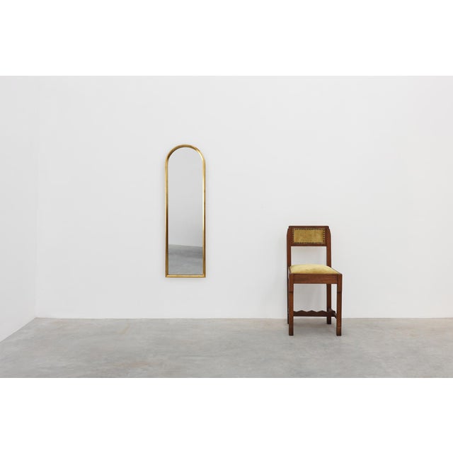 A refined arched wall mirror by the Belgian manufacturer Deknudt, produced in the second half of the 20th century. The...